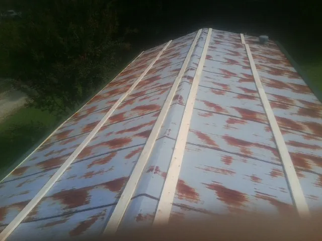Rusted metal roof panels with new wood purlins before replacement — Storm Damage Roof Repair in Peterboro by Roofing Brothers