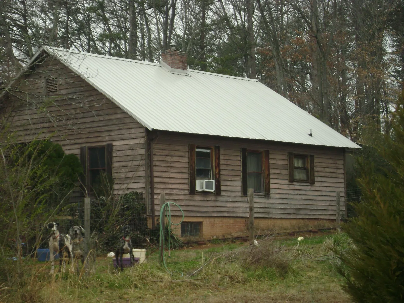 White metal roof on an old wood sided farmhouse, from a Metal Roof Installation job in Peterboro